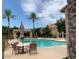 Resort-style pool area with lounge chairs, shaded seating, and lush landscaping for relaxation at 3521 N Hooper St, Buckeye, AZ 85396