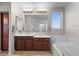 Well-lit bathroom with dual vanity, soaking tub, and lots of storage space at 35746 N 32Nd Ln, Phoenix, AZ 85086