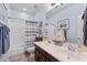 Nautical themed bathroom with double vanity, tub with shower, and tile flooring at 35746 N 32Nd Ln, Phoenix, AZ 85086