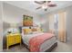 Bright bedroom featuring a ceiling fan, yellow bedside tables, and decorative bedding at 35746 N 32Nd Ln, Phoenix, AZ 85086