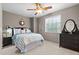 Comfortable bedroom with a ceiling fan, natural light, and modern decor at 35746 N 32Nd Ln, Phoenix, AZ 85086