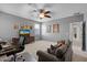 Large bonus room with a ceiling fan, tv, couch, and desk with comfortable chair at 35746 N 32Nd Ln, Phoenix, AZ 85086