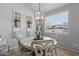 Charming dining area with a decorative chandelier, stylish seating, and natural light at 35746 N 32Nd Ln, Phoenix, AZ 85086