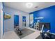 Bright exercise room with blue accent wall, mirrors, and modern fitness equipment at 35746 N 32Nd Ln, Phoenix, AZ 85086