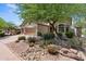 Beautiful desert landscaping surrounding a two-story home with a three-car garage and stone detailing at 35746 N 32Nd Ln, Phoenix, AZ 85086