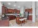 Well-appointed kitchen featuring dark wood cabinetry, granite countertops, a center island, and stainless-steel appliances at 35746 N 32Nd Ln, Phoenix, AZ 85086