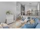 Spacious living room with a view of the dining area, cozy seating, and natural light at 35746 N 32Nd Ln, Phoenix, AZ 85086