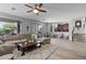 Open-concept living room with tile floors, neutral colors, and staircase with wrought iron accents at 35746 N 32Nd Ln, Phoenix, AZ 85086