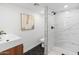 Modern bathroom features a walk-in shower with sleek fixtures, vanity sink and hexagon tile flooring at 3824 W Puget Ave, Phoenix, AZ 85051