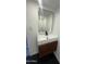 Modern bathroom sink with dark faucet, square mirror and wood paneling at 3824 W Puget Ave, Phoenix, AZ 85051