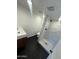 Bathroom with a tiled shower, dark mosaic tile flooring, and modern fixtures at 3824 W Puget Ave, Phoenix, AZ 85051