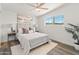 Bright bedroom with white walls, wood-look flooring, ceiling fan, and cozy decor at 3824 W Puget Ave, Phoenix, AZ 85051