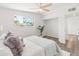 Light-filled bedroom features a ceiling fan and wood-look floors at 3824 W Puget Ave, Phoenix, AZ 85051