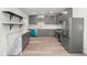 Spacious kitchen with gray cabinetry, marble counters, stainless appliances, and wood-look floors at 3824 W Puget Ave, Phoenix, AZ 85051