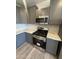 Grey kitchen features stainless steel appliances and stylish backsplash and countertops at 3824 W Puget Ave, Phoenix, AZ 85051