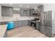 Beautiful kitchen featuring gray cabinets, stainless steel appliances, and wood-look flooring at 3824 W Puget Ave, Phoenix, AZ 85051