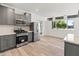 Bright kitchen with stainless steel appliances, gray cabinets, and large window at 3824 W Puget Ave, Phoenix, AZ 85051