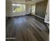 Bright living room featuring wood floors, lots of windows, and a modern accent wall at 3824 W Puget Ave, Phoenix, AZ 85051