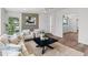 Bright living room showcasing modern decor, neutral color scheme, and wood-look flooring at 3824 W Puget Ave, Phoenix, AZ 85051