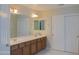 Bathroom featuring a double sink vanity and a large mirror, complemented by bright lighting at 4187 N 298Th Ln, Buckeye, AZ 85396