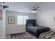A cozy bedroom features a ceiling fan and neutral decor, creating a calming atmosphere at 4187 N 298Th Ln, Buckeye, AZ 85396