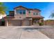 Charming two-story home with a three-car garage and a well-maintained front yard at 4187 N 298Th Ln, Buckeye, AZ 85396