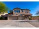 Beautiful two-story home with a three-car garage, manicured front yard, and desert landscaping at 4187 N 298Th Ln, Buckeye, AZ 85396