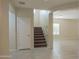 Foyer with tile flooring, staircase, and plenty of natural light at 4187 N 298Th Ln, Buckeye, AZ 85396