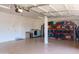 Spacious garage with laundry area, storage shelving and a garage door for secure parking and storage at 4187 N 298Th Ln, Buckeye, AZ 85396