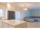 Kitchen with white cabinets, stainless steel appliances, and seamless flow into the living space at 4187 N 298Th Ln, Buckeye, AZ 85396