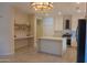 Bright kitchen featuring white cabinets, stainless steel appliances, and a spacious central island at 4187 N 298Th Ln, Buckeye, AZ 85396