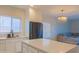 Modern kitchen with stainless steel appliances, quartz countertops, and seamless flow into the living space at 4187 N 298Th Ln, Buckeye, AZ 85396