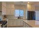 Bright kitchen features white cabinets, stainless steel appliances, and a large island at 4187 N 298Th Ln, Buckeye, AZ 85396