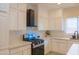 Close up of a well-equipped kitchen featuring white cabinets, modern appliances, and bright countertops at 4187 N 298Th Ln, Buckeye, AZ 85396