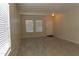 Neutral living room with tile flooring and multiple windows at 4187 N 298Th Ln, Buckeye, AZ 85396