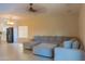 Spacious living room with a cozy sectional, showcasing the home's comfortable and stylish interior at 4187 N 298Th Ln, Buckeye, AZ 85396