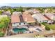 Aerial view of the property showcasing the fenced backyard, pool, patio, and surrounding neighborhood at 4329 W Electra Ln, Glendale, AZ 85310
