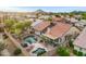 Aerial view of a private backyard with a pool, covered patio, and a serene desert landscape at 4329 W Electra Ln, Glendale, AZ 85310