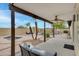 Covered patio overlooking a backyard with a multi-pool setup and desert landscaping at 4329 W Electra Ln, Glendale, AZ 85310