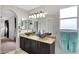Bathroom featuring dual vessel sinks, granite counters, and vanity lighting at 4329 W Electra Ln, Glendale, AZ 85310