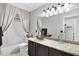 Bathroom with a granite countertop, vessel sink, and combination tub and shower at 4329 W Electra Ln, Glendale, AZ 85310