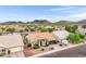 Inviting home exterior with a well-manicured lawn, two-car garage, and beautiful desert surroundings at 4329 W Electra Ln, Glendale, AZ 85310