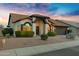 Charming single-story home featuring desert landscaping, a two-car garage, and a welcoming front porch at 4329 W Electra Ln, Glendale, AZ 85310