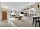 Spacious game room with a pool table, bar seating, and bright natural light at 4329 W Electra Ln, Glendale, AZ 85310