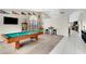 Spacious game room with a pool table, bar seating, and bright natural light at 4329 W Electra Ln, Glendale, AZ 85310