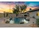Backyard pool with waterfall, desert landscaping and accent lights at 4329 W Electra Ln, Glendale, AZ 85310