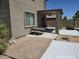 Outdoor patio space featuring a table, chairs, and drought-tolerant landscaping at 43455 W Chisholm Dr, Maricopa, AZ 85138