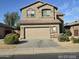 Two story home showcasing desert landscaping, attached two car garage and tile roof at 43455 W Chisholm Dr, Maricopa, AZ 85138