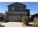 Charming two-story home featuring desert landscaping, a two-car garage and a neutral color scheme at 43455 W Chisholm Dr, Maricopa, AZ 85138