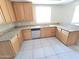 Kitchen featuring oak cabinets, stainless steel appliances and granite counters on a white tile floor at 43455 W Chisholm Dr, Maricopa, AZ 85138